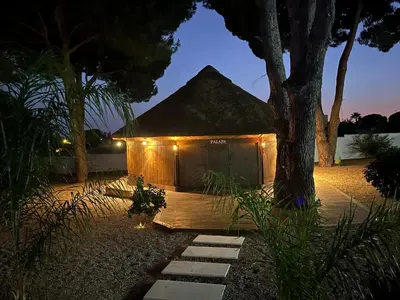 a small tent with lights in a yard at night at CÁDIZ -TIPI en Chiclana de la frontera, España in Chiclana de la Frontera