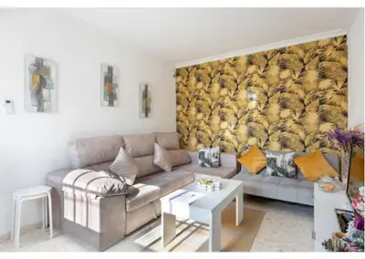 a living room with a couch and a table at La Rosa de Oro in Jerez de la Frontera