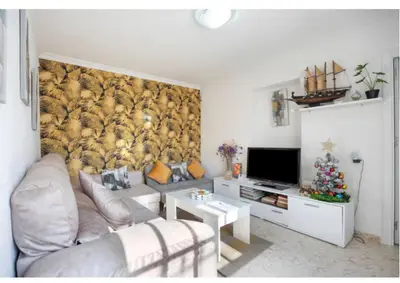a living room with a couch and a wall mural at La Rosa de Oro in Jerez de la Frontera