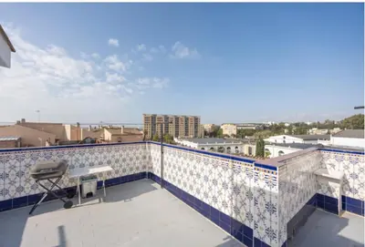 a balcony with blue and white tiles on a building at La Rosa de Oro in Jerez de la Frontera