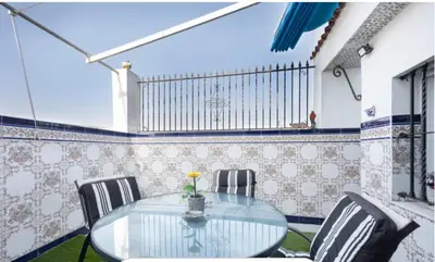 a dining room with a glass table and chairs at La Rosa de Oro in Jerez de la Frontera