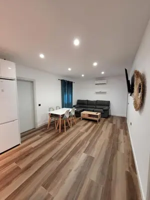 a living room with a couch and a table at Caímachado in Cádiz