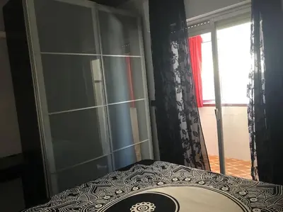 a room with a table and a glass door with a window at Apartamento Bulerias de Jerez in Jerez de la Frontera