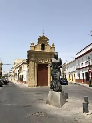 a statue of a woman standing in the middle of a street at Apartamento Bulerias de Jerez in Jerez de la Frontera
