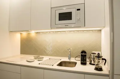 a kitchen with a sink and a microwave at Torre Solana 41 in Cádiz