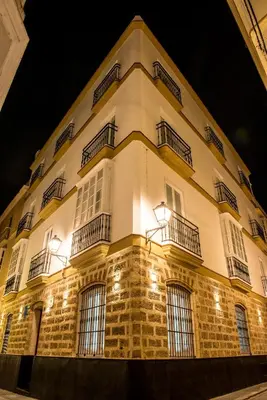 a large building with lights on it at night at Torre Solana 41 in Cádiz