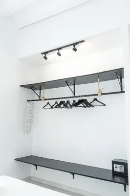 a shelf in a white wall with black shelves at Torre Solana 41 in Cádiz