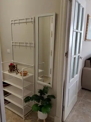 a mirror in a room with a plant next to it at LOS MELLIS in Sanlúcar de Barrameda