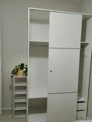 a white closet with a mirror and a plant at LOS MELLIS in Sanlúcar de Barrameda