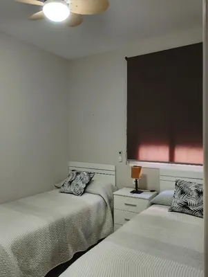a bedroom with two beds and a black board at LOS MELLIS in Sanlúcar de Barrameda