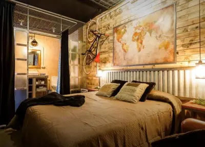 a bedroom with a bed with a bicycle on the wall at Gatu Selecta 5 Diseño calidad wifi, aire acc junto recinto ferial, Preferente mayores de 21 años y familias in Jerez de la Frontera