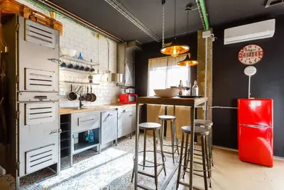 a kitchen with a red refrigerator and bar stools at Gatu Selecta 5 Diseño calidad wifi, aire acc junto recinto ferial, Preferente mayores de 21 años y familias in Jerez de la Frontera