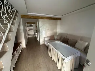 a living room with a couch and a table at Duplex centro/playa in Sanlúcar de Barrameda