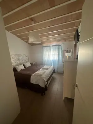 a bedroom with a large bed in a room at Duplex centro/playa in Sanlúcar de Barrameda