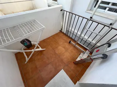 an overhead view of a staircase with a table on a floor at Duplex centro/playa in Sanlúcar de Barrameda