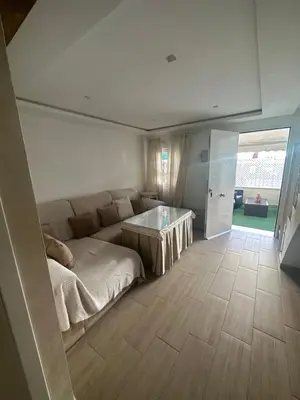 a living room with a couch and a table at Duplex centro/playa in Sanlúcar de Barrameda
