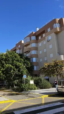 a parking lot in front of a large building at Karma loft en la playa by Sanlúcar Housing in Sanlúcar de Barrameda