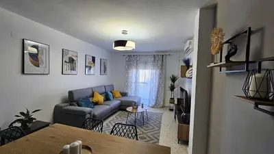 a living room with a couch and a table at Karma loft en la playa by Sanlúcar Housing in Sanlúcar de Barrameda