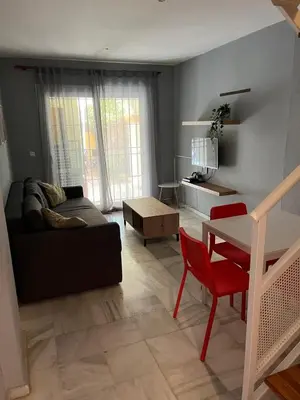 a living room with a couch and a table at Apartamento Red -primera linea de playa in El Puerto de Santa María