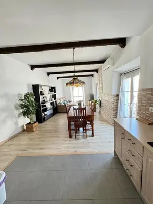 a kitchen and living room with a table and a dining room at Cabildo 2 in Sanlúcar de Barrameda