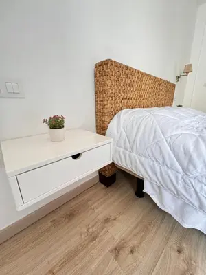 a bedroom with a white bed and a white dresser at Cabildo 2 in Sanlúcar de Barrameda