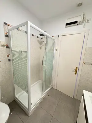 a shower with a glass door in a bathroom at Cabildo 2 in Sanlúcar de Barrameda