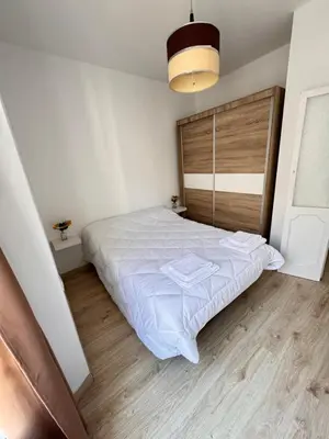 a bedroom with a large bed with a wooden headboard at Cabildo 2 in Sanlúcar de Barrameda