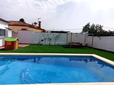 a swimming pool in the backyard of a house at Chalet Vacacional Chiclana in Chiclana de la Frontera