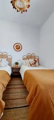 two beds sitting next to each other in a bedroom at Chalet Vacacional Chiclana in Chiclana de la Frontera
