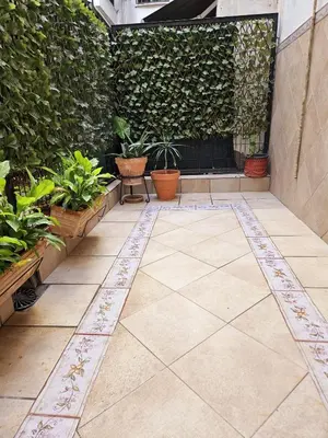 a patio with potted plants and a fireplace at Apartamento Vetalegua Jerez in Jerez de la Frontera
