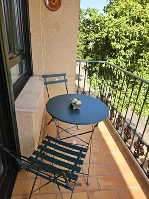 a blue table and chairs on a balcony at Apartamento Vetalegua Jerez in Jerez de la Frontera