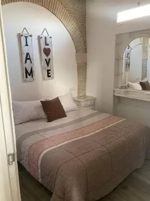 a bedroom with a large bed and a mirror at Casa Puerta sierra de Cádiz in Arcos de la Frontera