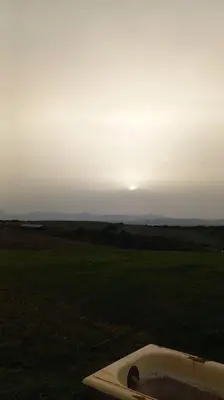 a bath tub in a field with the sunset in the background at Casa Puerta sierra de Cádiz in Arcos de la Frontera