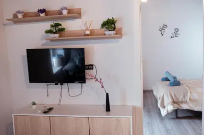 a television on a cabinet in a living room at APARTAMENTO EL EMBRUJO in Jerez de la Frontera