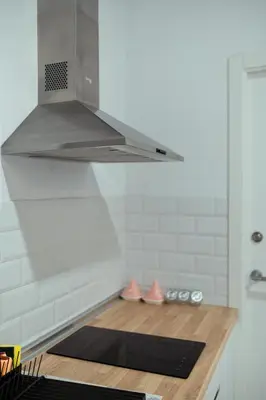 a kitchen with a hood over a black yoga mat at APARTAMENTO EL EMBRUJO in Jerez de la Frontera