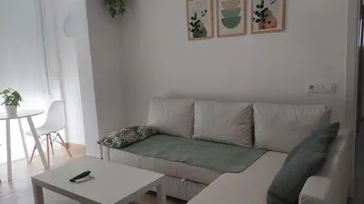a living room with a couch and a table at Casa Ángeles in Cádiz