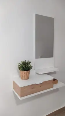 a tv on a white shelf with a potted plant at Casa Ángeles in Cádiz