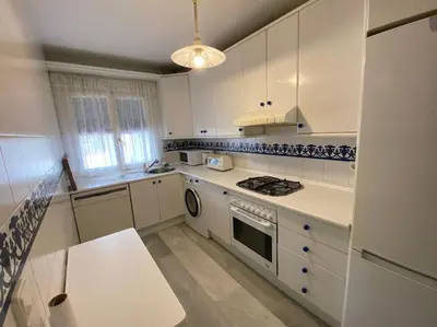 a kitchen with white cabinets and a stove top oven at Cozy Apart. Costa Sancti Petri by Chiclana Dreams in Novo Sancti Petri