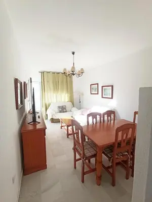 a dining room with a table and a bedroom at Apartamento Costa de Sancti Petri by Chiclana Dreams in Novo Sancti Petri