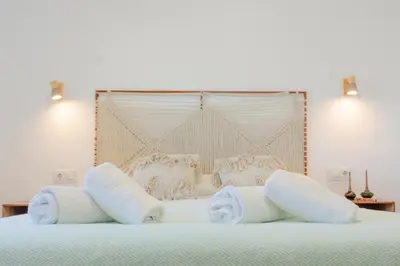 a bed with white towels on top of it at Moon Villa Conil con piscina in Conil de la Frontera