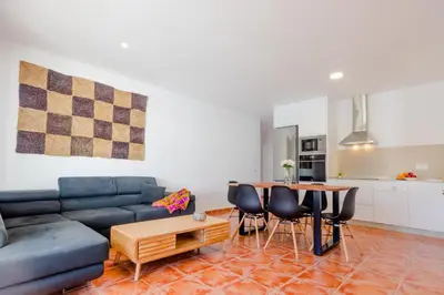 a living room with a blue couch and a table at Moon Villa Conil con piscina in Conil de la Frontera