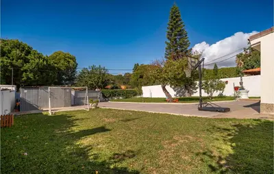 a yard with a tree and a basketball hoop at Lovely Home In Chiclana De La Fronter in Chiclana de la Frontera