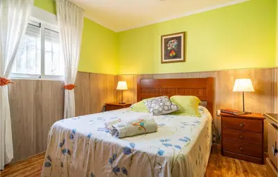 a bedroom with a bed with two pillows on it at Lovely Home In Chiclana De La Fronter in Chiclana de la Frontera