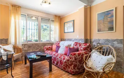 a living room with a couch and a table at Lovely Home In Chiclana De La Fronter in Chiclana de la Frontera