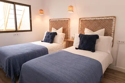 two beds sitting next to each other in a room at Calvario 53 by 7Escalones in Rota
