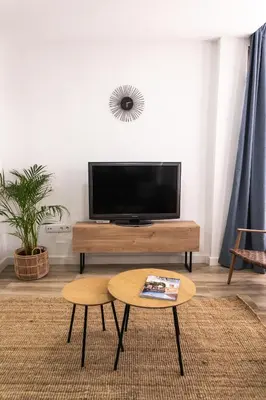 a living room with a tv and a coffee table at Calvario 53 by 7Escalones in Rota