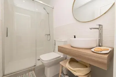 a bathroom with a toilet and a sink and a mirror at Vegaluz in Jerez de la Frontera