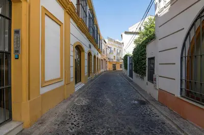 an empty street in an alley between buildings at Vegaluz in Jerez de la Frontera