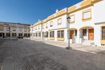 a street with white buildings and a light pole at Vegaluz in Jerez de la Frontera
