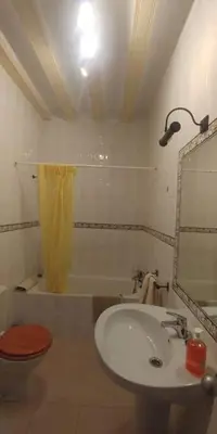 a bathroom with a sink and a toilet and a mirror at Las 4 Torres by Gades Gestión in Cádiz
